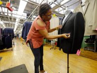 Quality control workers perform a final inspection of complete suits before they are shipped out, at the Joseph Abboud manufacturing plant in New Bedford, MA.   [ PETER PEREIRA/THE STANDARD-TIMES/SCMG ]